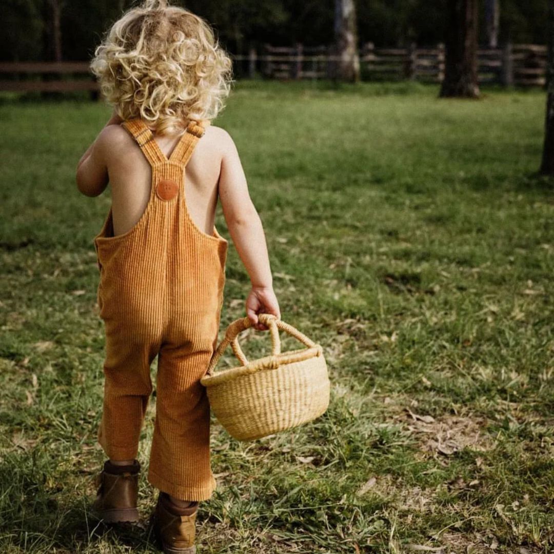 organic cotton long overalls in colour orange for kids, infants and toddlers. Sustainable childrens clothing in corduroy fabric
