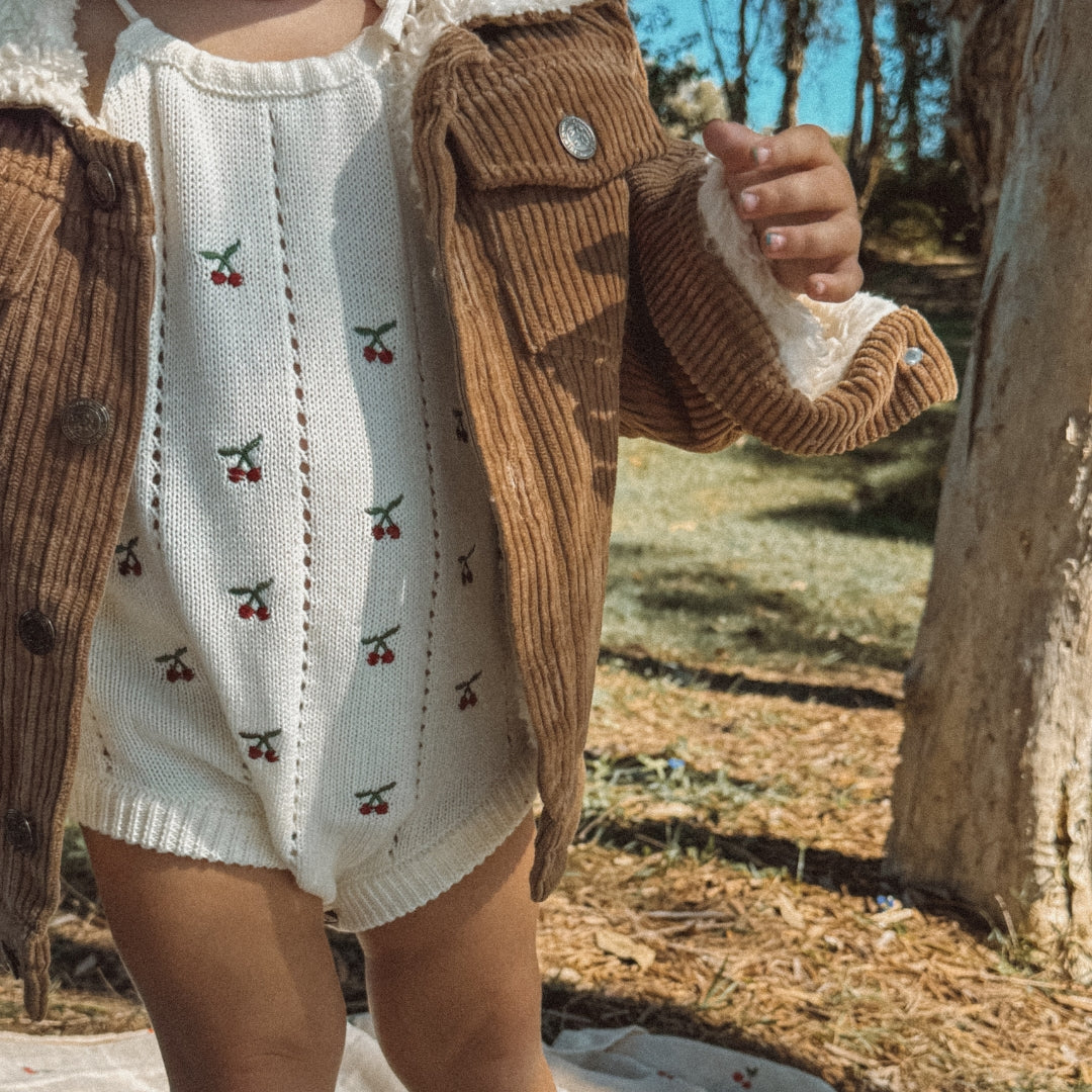 toddler wearing a corduroy jacket with sherpa fleece made from organic cotton close up