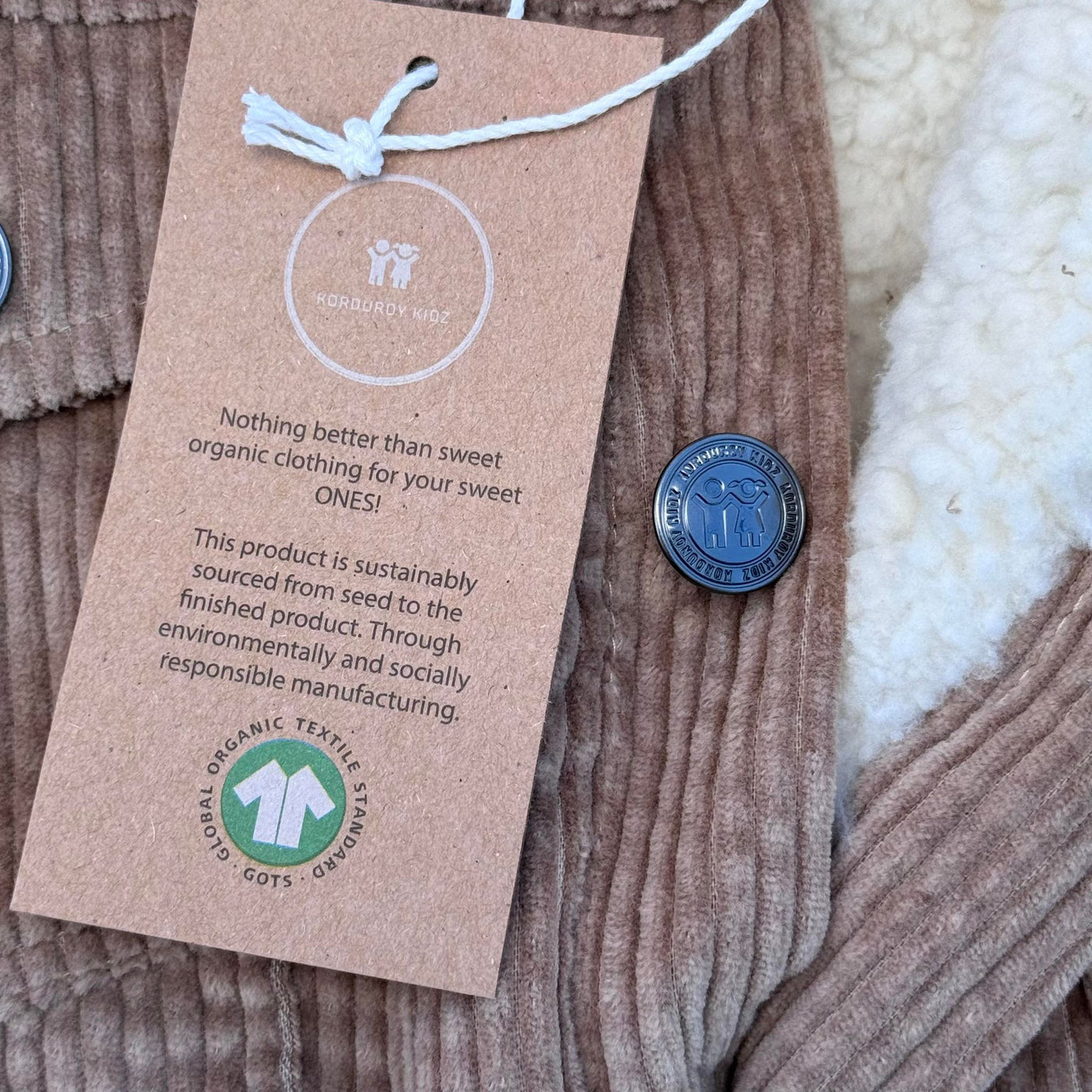 organic cotton corduroy clothing with a hang tag displaying GOTS Symbol