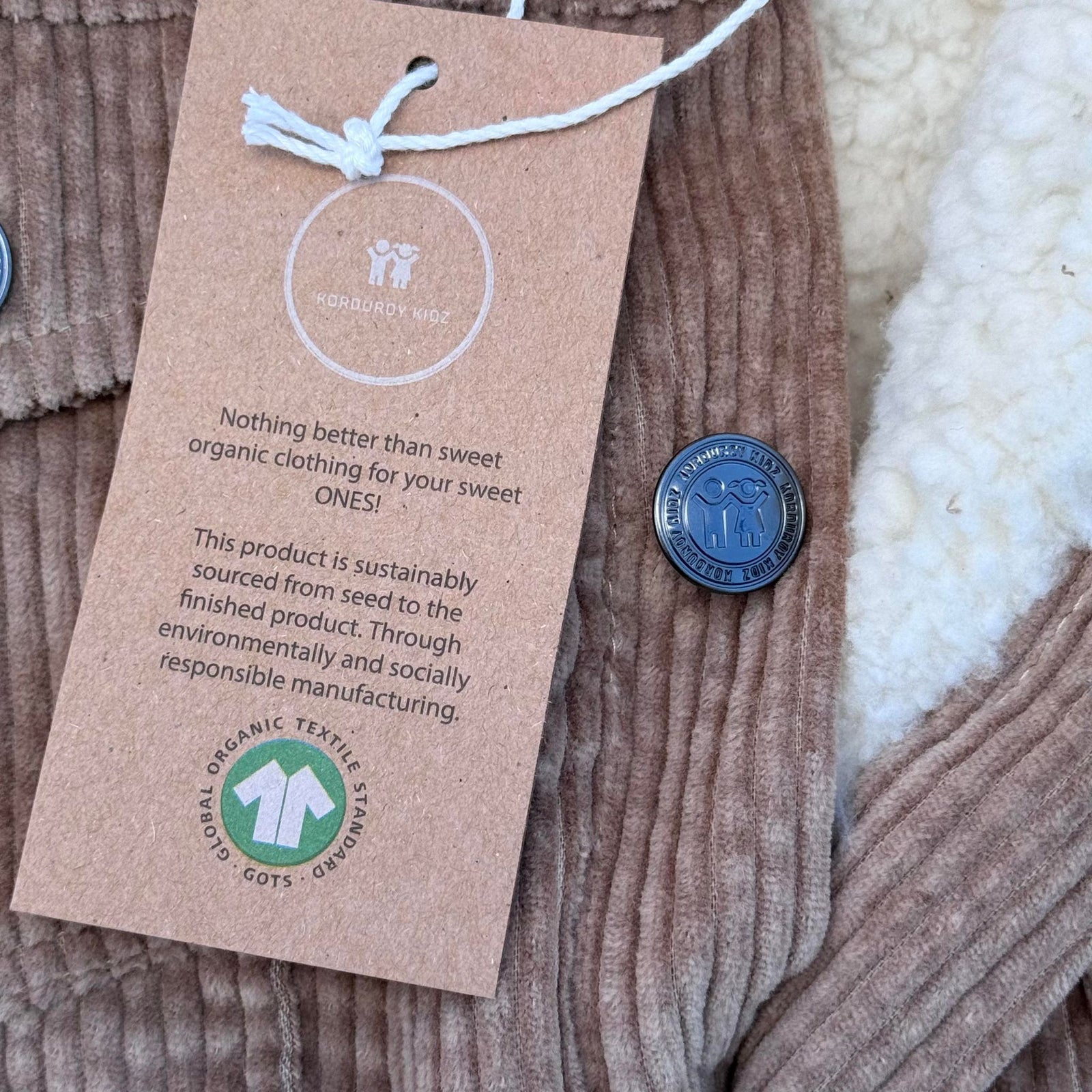 organic cotton corduroy clothing with a hang tag displaying GOTS Symbol