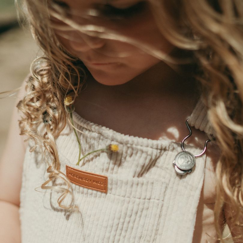 begie Kids and toddlers corduroy flare overalls or dungarees close up