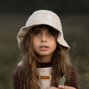 girl wearing her Kids and toddlers beige colour corduroy bucket hat