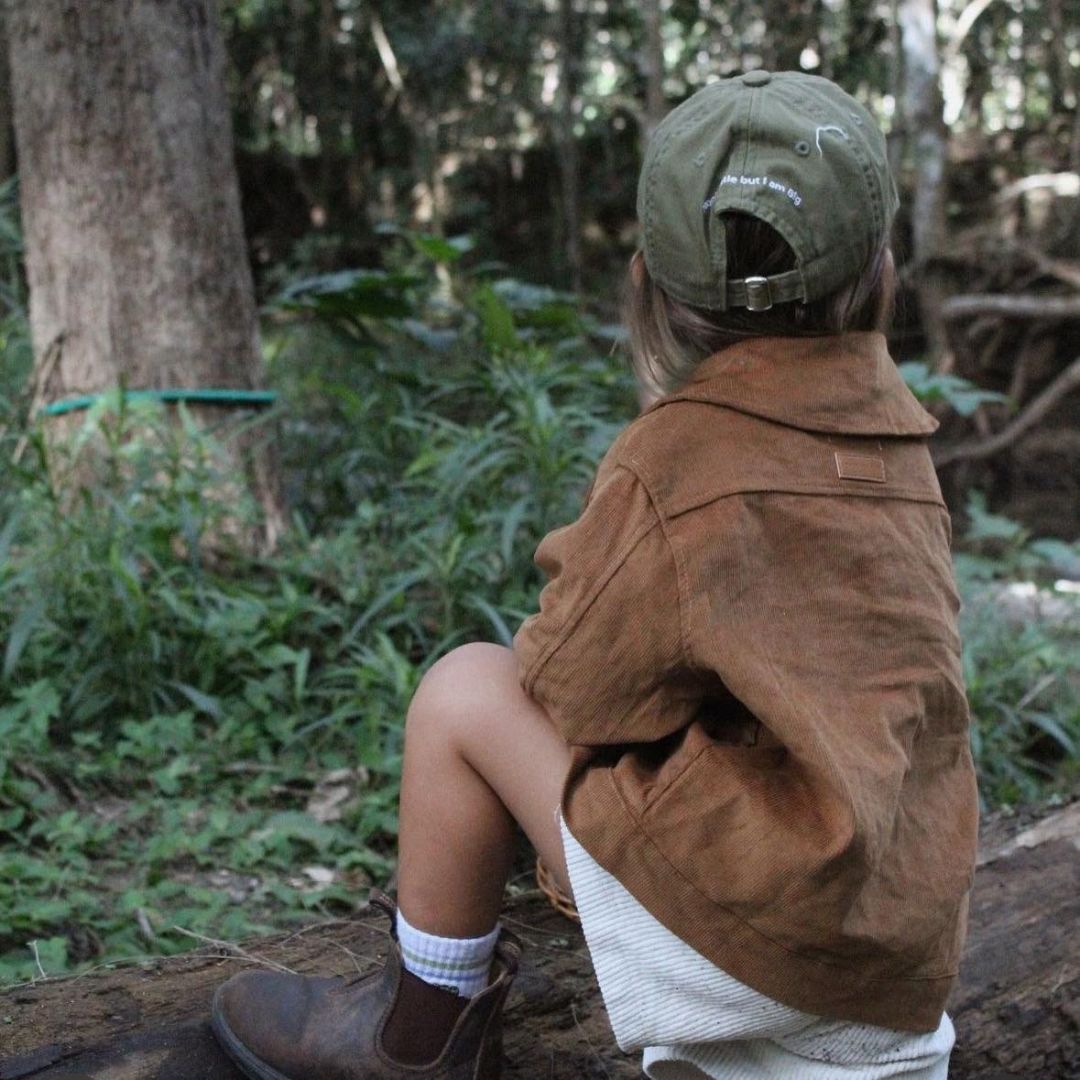 Kids and toddlers chocolate corduroy long sleeve dress shirt with a beautiful back drop of nature