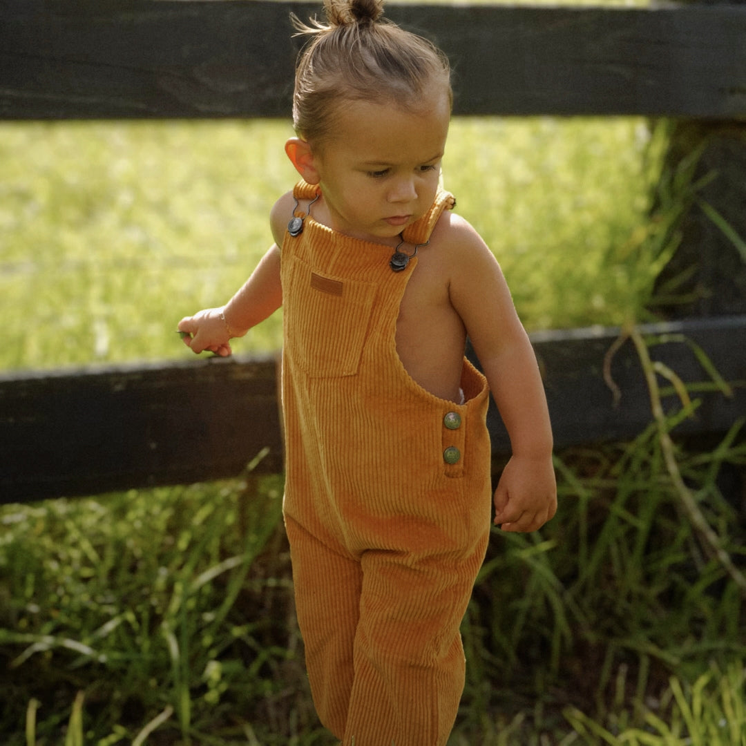 organic cotton corduroy long leg overalls in a orange for kids, toddlers and infants other side view