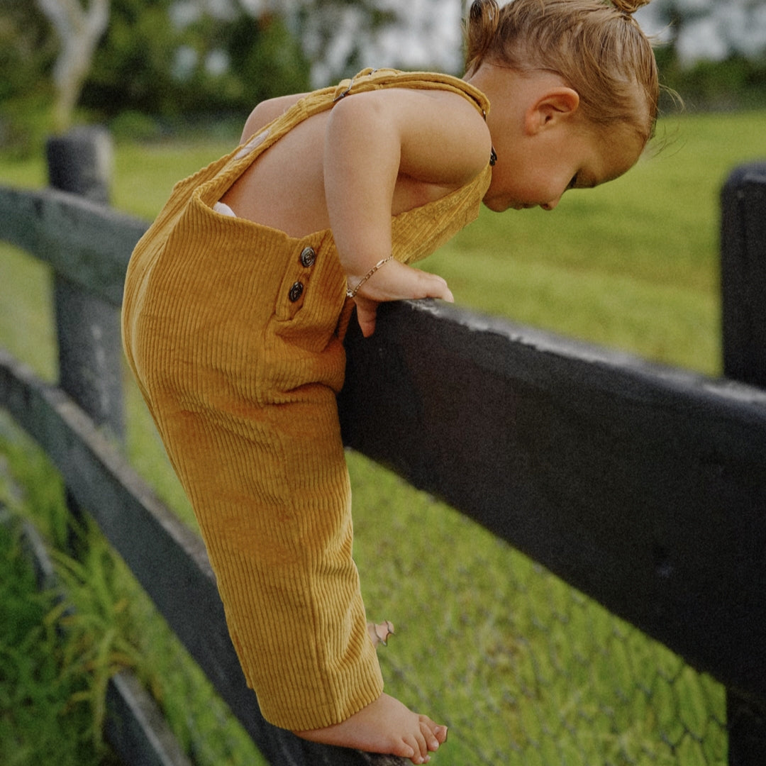 organic cotton corduroy long leg overalls in a orange for kids, toddlers and infants side view