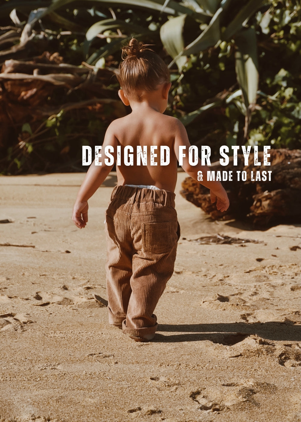 organic cotton corduroy pants in colour tan. Made for kids, toddlers and infants. Child is on the sand at the beach