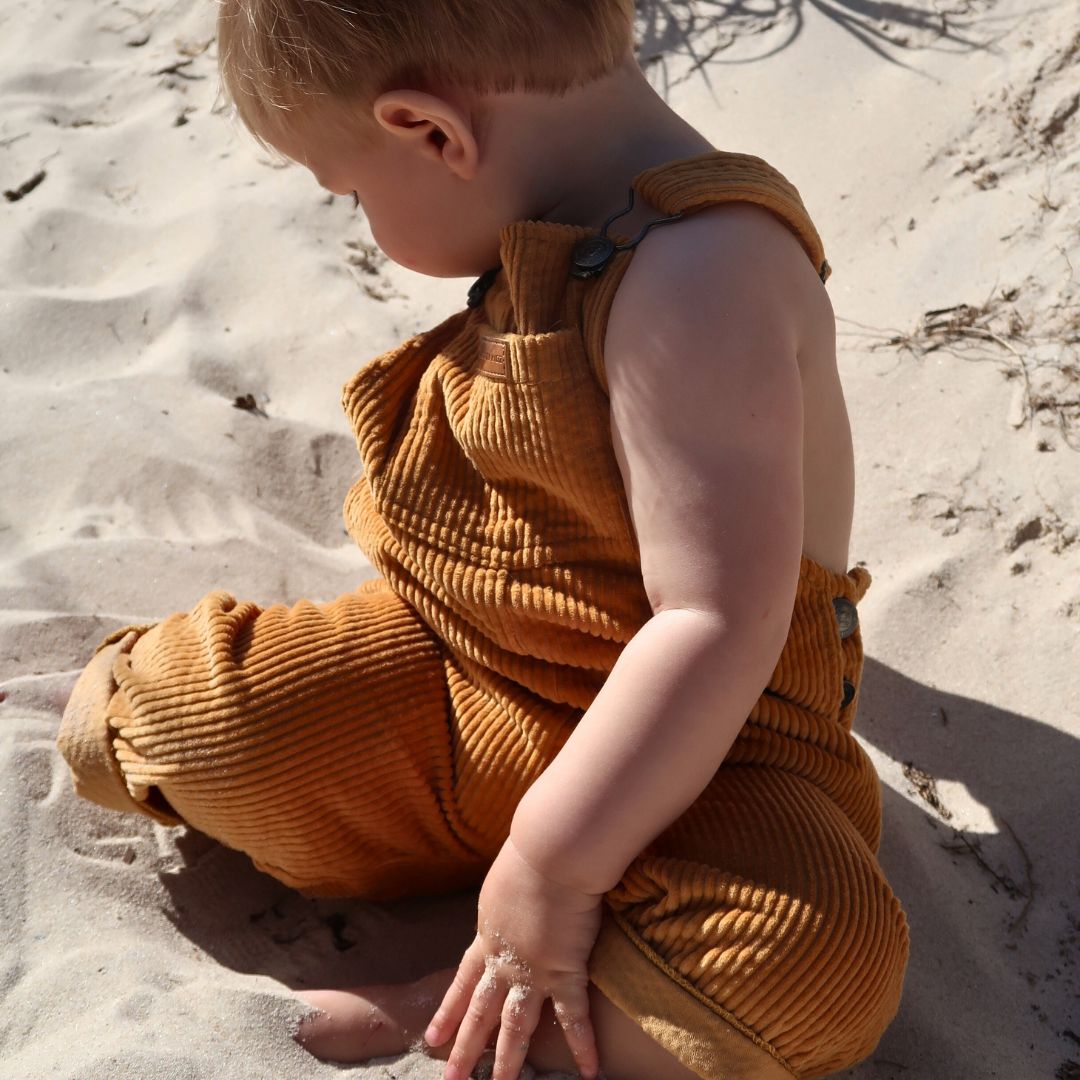 organic cotton corduroy long leg overalls in a orange for kids, toddlers and infants side view