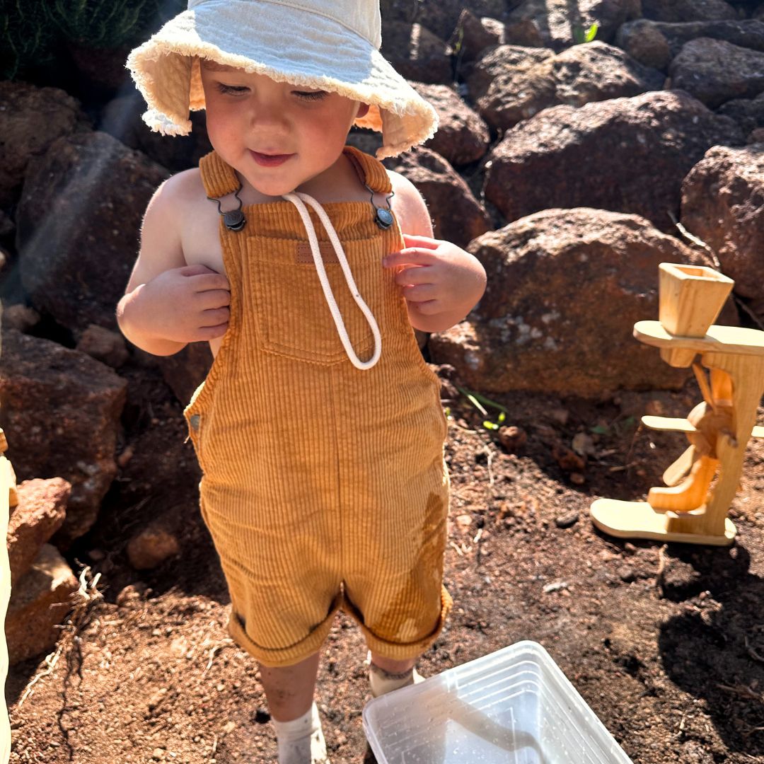organic cotton corduroy short leg overalls in a orange for kids, toddlers and infants front