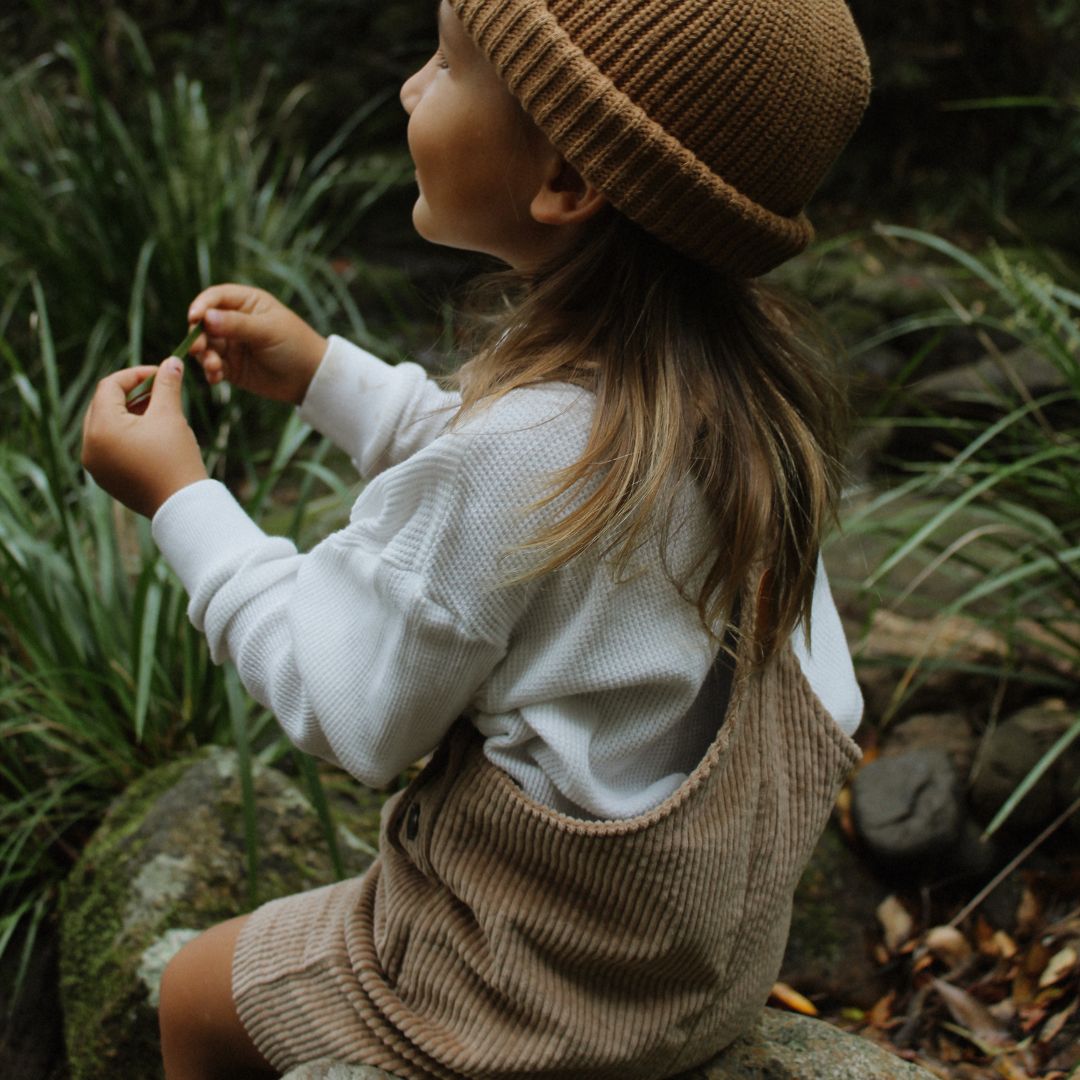 organic cotton corduroy short leg overalls in a tan for kids, toddlers and infants back biew side