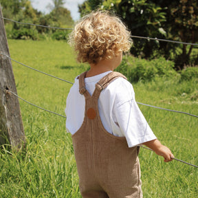 organic cotton corduroy short leg overalls in a tan for kids, toddlers and infants back view 1