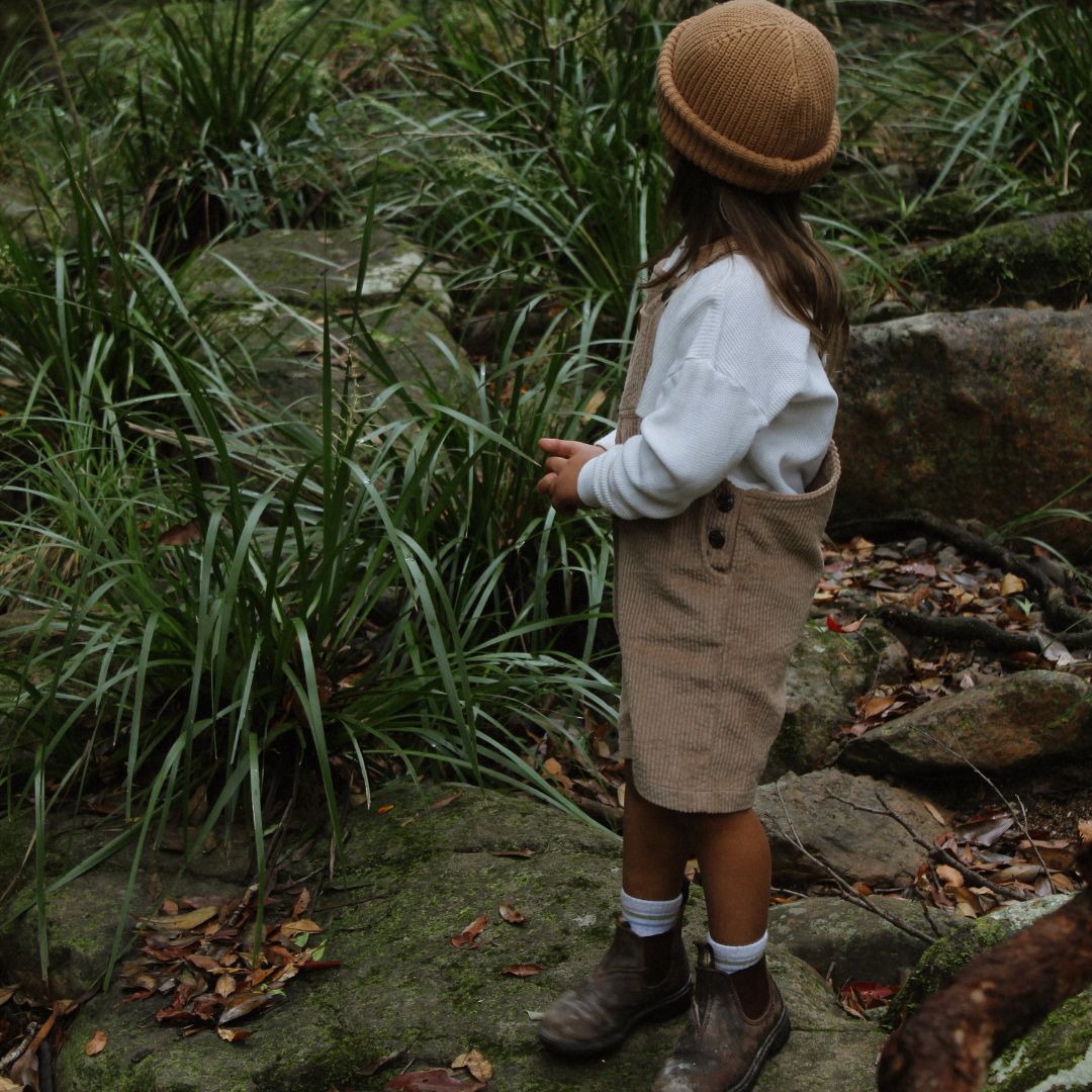 organic cotton corduroy short leg overalls in a tan for kids, toddlers and infants side view