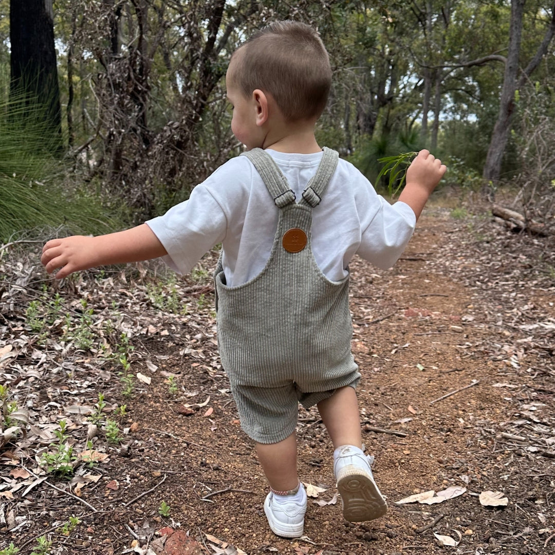 short leg overall, dungaree in colour sage made from organic cotton corduroy clothing for infants, toddlers and kids back view